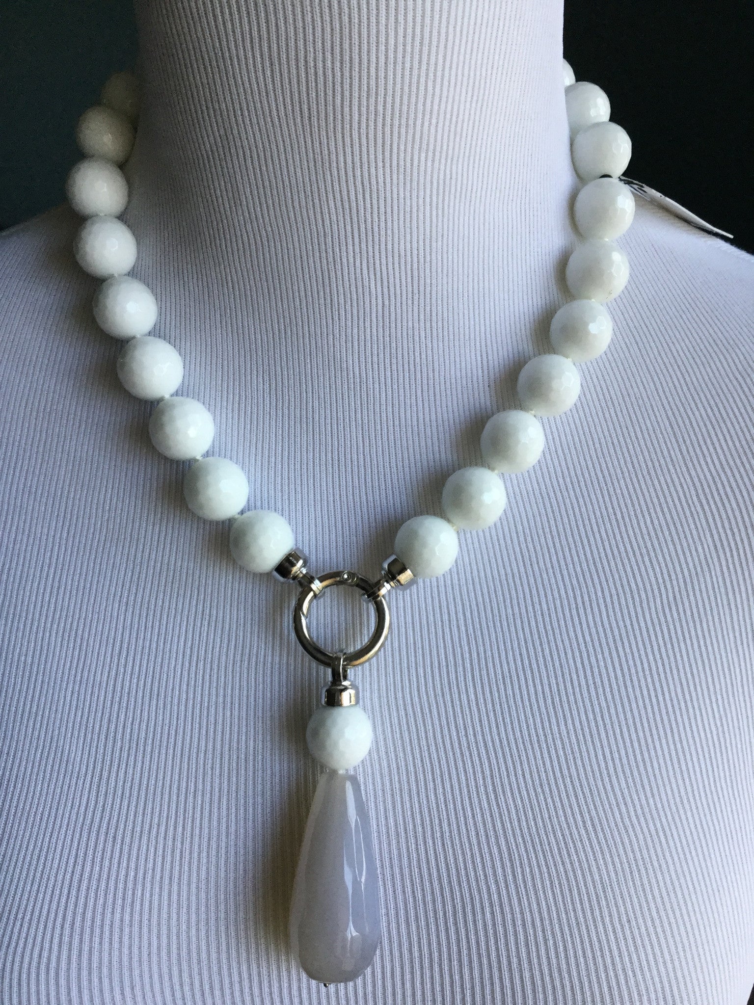 White raw bead necklace with stone drop. Opens at the front.